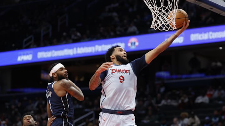 Dec 5, 2024; Washington, District of Columbia, USA; Washington Wizards forward Justin Champagnie (9) shoots the ball as Dallas Mavericks guard Jaden Hardy (1) looks on in the fourth quarter at Capital One Arena. Mandatory Credit: Geoff Burke-Imagn Images