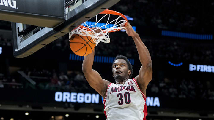 Mar 23, 2025; Seattle, WA, USA;  Arizona Wildcats forward Tobe Awaka (30) dunks the ball against the Oregon Ducks in the first half at Climate Pledge Arena. Mandatory Credit: Stephen Brashear-Imagn Images