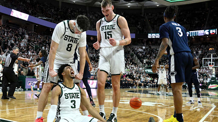 Jan 15, 2025; East Lansing, Michigan, USA;  Michigan State Spartans guard Jaden Akins (3) celebrates with  forward Frankie Fidler (8) and center Carson Cooper (15) after he scoring against the Penn State Nittany Lions during the second half at Jack Breslin Student Events Center.  Mandatory Credit: Dale Young-Imagn Images