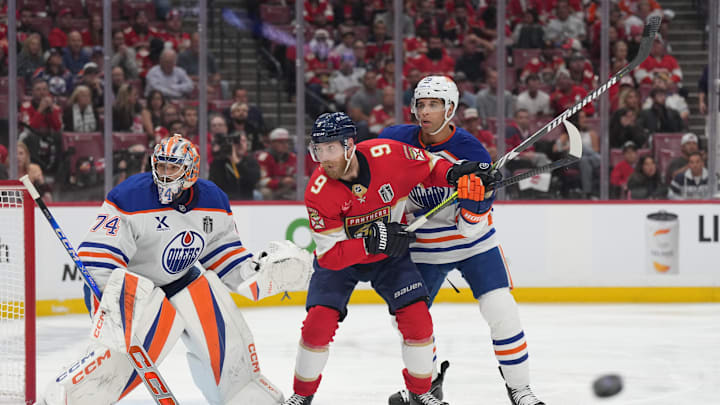 Jun 9, 2025; Sunrise, Florida, USA; Edmonton Oilers goaltender Stuart Skinner (74) and defenseman Darnell Nurse (25) defend against Florida Panthers forward Sam Bennett (9) during the second period in game three of the 2025 Stanley Cup Final at Amerant Bank Arena.