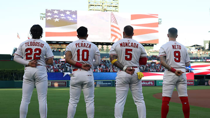Sep 8, 2025; Anaheim, California, USA;  Los Angeles Angels center fielder Bryce Teodosio (22) and first baseman Oswald Peraza (10) and third baseman Yoan Moncada (5) and shortstop Zach Neto (9) line up during a national anthem before the game against the Minnesota Twins at Angel Stadium. Mandatory Credit: Kiyoshi Mio-Imagn Images