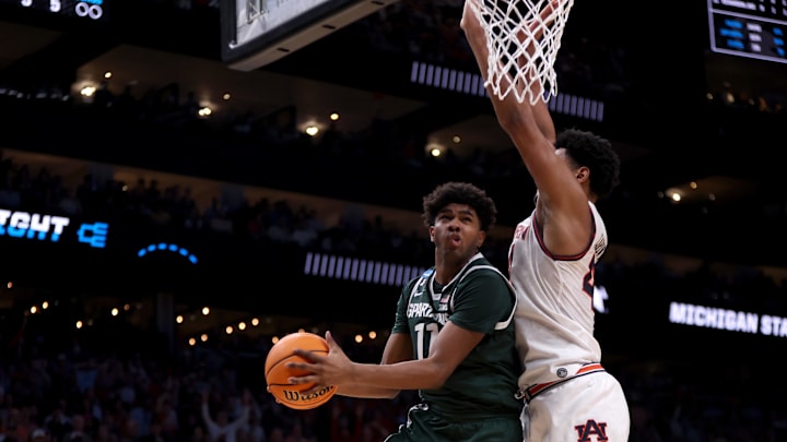 Mar 30, 2025; Atlanta, GA, USA; Michigan State Spartans guard Jase Richardson (11) drives against Auburn Tigers center Dylan Cardwell (44) during the second half in the South Regional final of the 2025 NCAA tournament at State Farm Arena. Mandatory Credit: Brett Davis-Imagn Images Mar 30, 2025; Atlanta, GA, USA; Michigan State Spartans guard Jase Richardson (11) drives against Auburn Tigers center Dylan Cardwell (44) during the second half in the South Regional final of the 2025 NCAA tournament at State Farm Arena. Mandatory Credit: Brett Davis-Imagn Images