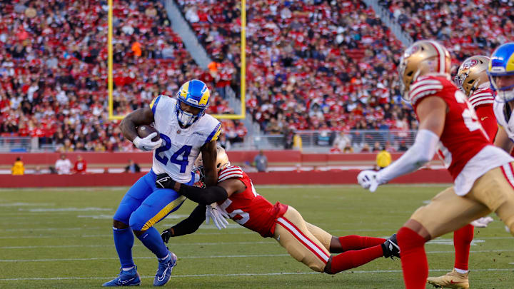 Jan 7, 2024; Santa Clara, California, USA; Los Angeles Rams running back Royce Freeman (24) is tackled by San Francisco 49ers linebacker Demetrius Flannigan-Fowles (45) during the third quarter at Levi's Stadium. Mandatory Credit: Sergio Estrada-Imagn Images
