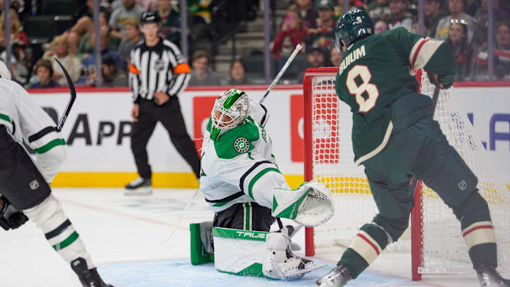 Sep 25, 2025; Saint Paul, Minnesota, USA; Dallas Stars goaltender Casey DeSmith (1) dives for a crossing pass to Minnesota Wild defenseman Zeev Buium (8) in the second period at Grand Casino Arena. Mandatory Credit: Matt Blewett-Imagn Images