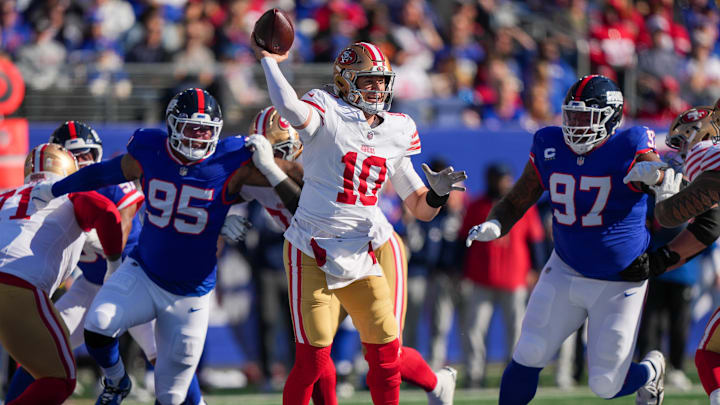 Nov 2, 2025; East Rutherford, New Jersey, USA; San Francisco 49ers quarterback Mac Jones (10) is pressured by New York Giants defensive tackle Roy Robertson-Harris (95) and defensive tackle Dexter Lawrence II (97) during the first half at MetLife Stadium. Mandatory Credit: Robert Deutsch-Imagn Images