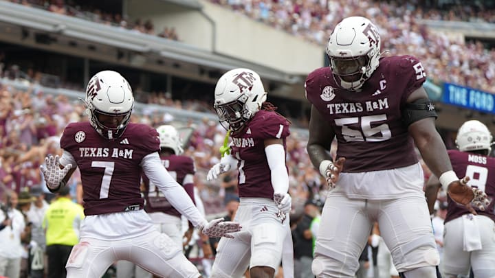 Texas A&M Aggies wide receiver KC Concepcion (7), Texas A&M Aggies wide receiver Mario Craver (1), and Texas A&M Aggies offensive lineman Ar'maj Reed-Adams (55) celebrate after a touchdown during the second quarter against the Utah State Aggies at Kyle Field. 