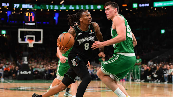 Mar 22, 2026; Boston, Massachusetts, USA; Minnesota Timberwolves guard Bones Hyland (8) drives to the basket while Boston Celtics center Luka Garza (52) defends during the second half at TD Garden. 