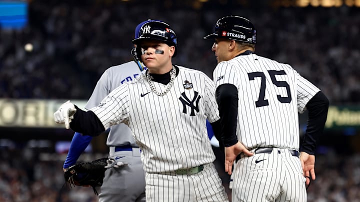 Oct 30, 2024; New York, New York, USA; New York Yankees outfielder Alex Verdugo (24) celebrates with first base coach Travis Chapman (75) after hitting a RBI single during the second inning against the Los Angeles Dodgers in game five of the 2024 MLB World Series at Yankee Stadium. Mandatory Credit: Vincent Carchietta-Imagn Images