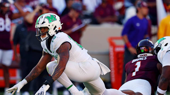 Sep 7, 2024; Blacksburg, Virginia, USA; Marshall Thundering Herd defensive lineman Mike Green (15) celebrates after sacking Virginia Tech Hokies quarterback Kyron Drones (1) during the first quarter at Lane Stadium. Mandatory Credit: Peter Casey-Imagn Images