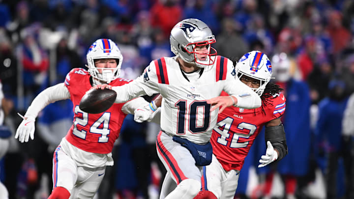 Dec 22, 2024; Orchard Park, New York, USA; New England Patriots quarterback Drake Maye (10) throws a pass under pressure from Buffalo Bills safety Cole Bishop (24) and linebacker Dorian Williams (42) in the fourth quarter at Highmark Stadium. Mandatory Credit: Mark Konezny-Imagn Images