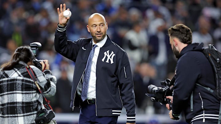 Oct 28, 2024; New York, New York, USA; New York Yankees former playing Derek Jeter waves to fans before throwing out the ceremonial first pitch before game three of the 2024 MLB World Series between the New York Yankees and the Los Angeles Dodgers at Yankee Stadium. Mandatory Credit: Brad Penner-Imagn Images