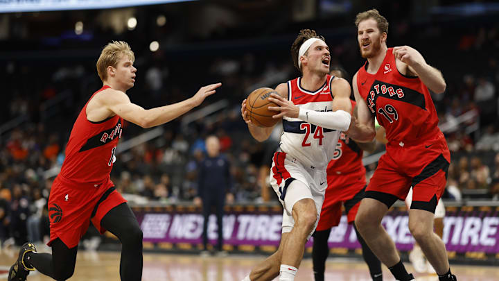 Oct 11, 2024; Washington, District of Columbia, USA; Washington Wizards forward Corey Kispert (24) drives to the basket as Toronto Raptors center Jakob Poeltl (19) defends in the second quarter at Capital One Arena. Mandatory Credit: Geoff Burke-Imagn Images