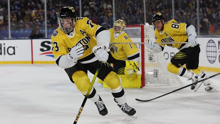 Feb 1, 2026; Tampa Bay, Florida, USA; Boston Bruins defenseman Charlie McAvoy (73) controls the puck Tampa Bay Lightning during overtime in the 2026 Stadium Series ice hockey game at Raymond James Stadium. Mandatory Credit: Kim Klement Neitzel-Imagn Images