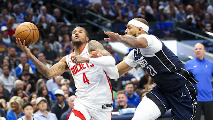 Oct 31, 2024; Dallas, Texas, USA;  Houston Rockets guard Jalen Green (4) drives to the basket as Dallas Mavericks center Daniel Gafford (21) defends during the first half at American Airlines Center. Mandatory Credit: Kevin Jairaj-Imagn Images