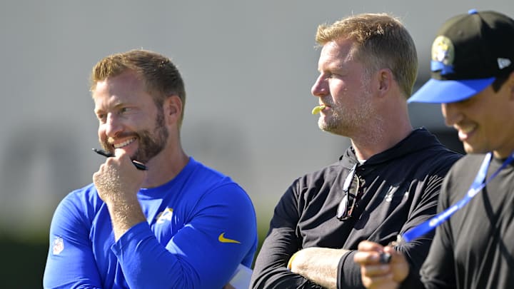 Jul 29, 2024; Los Angeles, CA, USA; Los Angeles Rams head coach Sean McVay, general manager Les Snead and chief of staff Carter Crutchfield talk on the field during training camp at Loyola Marymount University. Mandatory Credit: Jayne Kamin-Oncea-Imagn Images