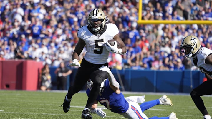 Sep 28, 2025; Orchard Park, New York, USA;  New Orleans Saints running back Kendre Miller (5) is tackled by Buffalo Bills cornerback Taron Johnson (7) during the fourth quarter at Highmark Stadium. Mandatory Credit: Gregory Fisher-Imagn Images