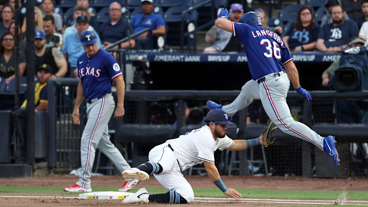 Jun 4, 2025; St. Petersburg, Florida, USA; Texas Rangers outfielder Wyatt Langford (36) jumps over Tampa Bay Rays first base Jonathan Aranda (62) as he jumps over as he is safe at fires base during the first inning at George M. Steinbrenner Field. Mandatory Credit: Kim Klement Neitzel-Imagn Images