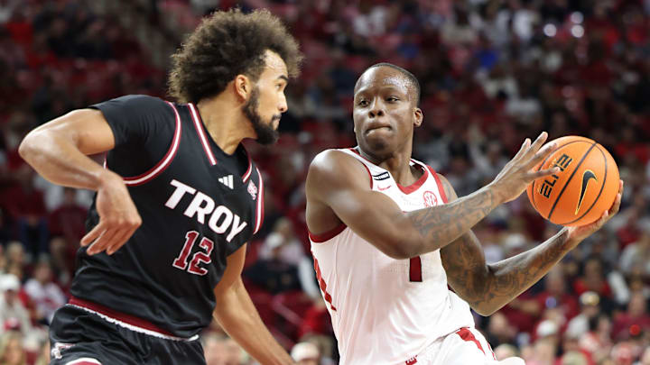Nov 13, 2024; Fayetteville, Arkansas, USA; Arkansas Razorbacks guard Johnell Davis (1) drives against Troy Trojans guard Tayton Conway (12) during the second half at Bud Walton Arena. Arkansas won 65-49. Mandatory Credit: Nelson Chenault-Imagn Images
