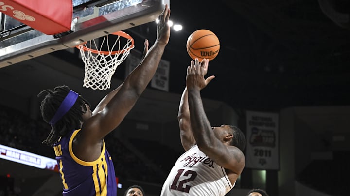 Jan 3, 2026; College Station, Texas, USA; Texas A&M Aggies forward Rashaun Agee (12) shoots the ball as Louisiana State Tigers center Michael Nwoko (1) defends at Reed Arena. Mandatory Credit: Maria Lysaker-Imagn Images 
