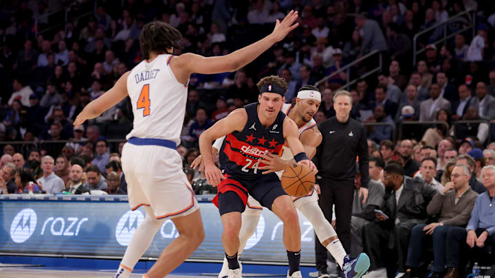Nov 18, 2024; New York, New York, USA; Washington Wizards forward Corey Kispert (24) controls the ball against New York Knicks guards Pacome Dadiet (4) and Josh Hart (3) during the second quarter at Madison Square Garden. Mandatory Credit: Brad Penner-Imagn Images