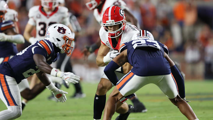 Oct 11, 2025; Auburn, Alabama, USA;  Auburn Tigers defensive back Kensley Louidor-Faustin (28) and cornerback Jay Crawford (23) close in on Georgia Bulldogs wide receiver London Humphreys (16) during the fourth quarter at Jordan-Hare Stadium. Mandatory Credit: John Reed-Imagn Images