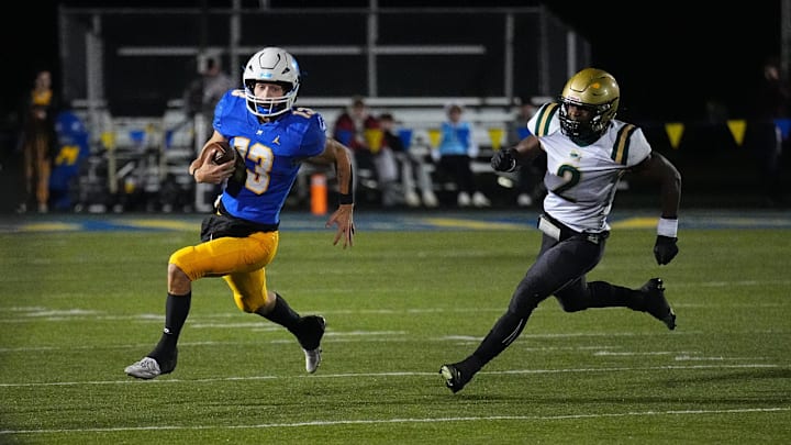 Mukwonago quarterback Mason Kelley (13) is pursued by Racine Case linebacker Mi'Sha Grayson (2) during the WIAA Level 2 playoff game at Mukwonago on Friday, Nov. 1, 2024.