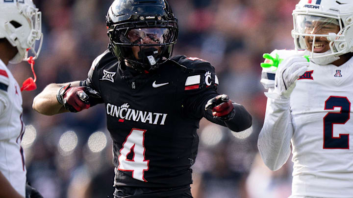 Cincinnati Bearcats wide receiver Cyrus Allen (4) gestures for a first down as Arizona Wildcats linebacker Jabari Mann (11) and Arizona Wildcats defensive back Treydan Stukes (2) react in the third quarter of the NCAA football game at Nippert Stadium in Cincinnati on Nov. 15, 2025.