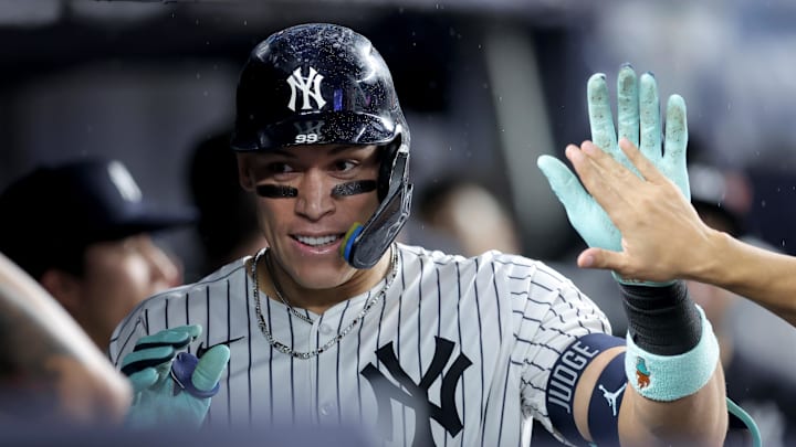 Sep 24, 2025; Bronx, New York, USA; New York Yankees right fielder Aaron Judge (99) celebrates his solo home run against the Chicago White Sox with teammates in the dugout during the eighth inning at Yankee Stadium. Mandatory Credit: Brad Penner-Imagn Images