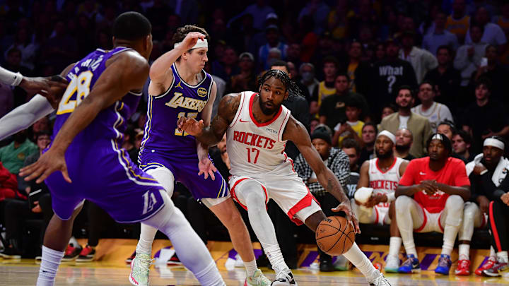 Apr 29, 2026; Los Angeles, California, USA; Houston Rockets forward Tari Eason (17) moves the ball against Los Angeles Lakers guard Austin Reaves (15) and forward Rui Hachimura (28) during the second half in game five of the first round of the 2026 NBA Playoffs at Crypto.com Arena. Mandatory Credit: Gary A. Vasquez-Imagn Images