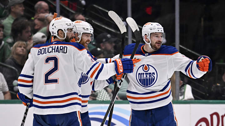 Edmonton Oilers defenseman Brett Kulak (27) and defenseman Evan Bouchard (2) and left wing Zach Hyman (18)