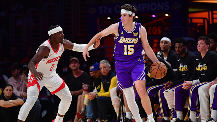 Apr 29, 2026; Los Angeles, California, USA; Los Angeles Lakers guard Austin Reaves (15) moves the ball against Houston Rockets guard Aaron Holiday (0) during the second half in game five of the first round of the 2026 NBA Playoffs at Crypto.com Arena. 
