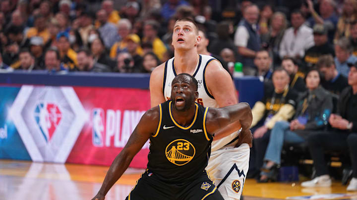 Apr 27, 2022; San Francisco, California, USA; Golden State Warriors forward Draymond Green (23) battles for position with Denver Nuggets center Nikola Jokic (15) in the first quarter during game five of the first round for the 2022 NBA playoffs at Chase Center. Mandatory Credit: Cary Edmondson-Imagn Images