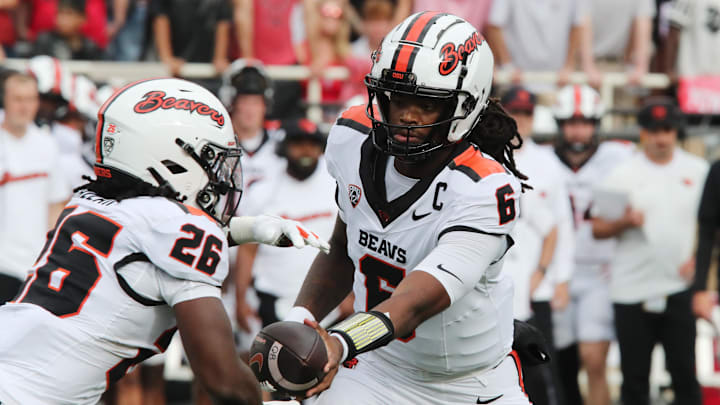 Sep 13, 2025; Lubbock, Texas, USA;  Oregon State Beavers quarterback Maalik Murphy (6) hands the ball in the first half to running back Salahadin Allah (26) during the game against the Texas Tech Red Raiders at Jones AT&T Stadium. Mandatory Credit: Michael C. Johnson-Imagn Images
