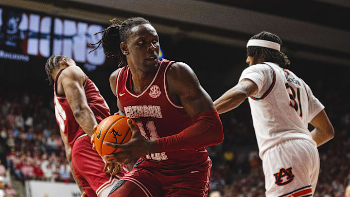 Feb 15, 2025; Tuscaloosa, Alabama, USA; Alabama Crimson Tide center Clifford Omoruyi (11) recovers a rebound against the Auburn Tigers during the first half at Coleman Coliseum. Mandatory Credit: Will McLelland-Imagn Images