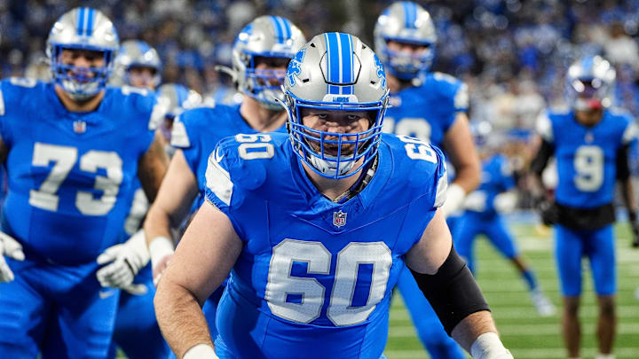 Detroit Lions guard Graham Glasgow (60) warms up before the NFC divisional round at Ford Field in Detroit on Saturday, Jan. 18, 2025.