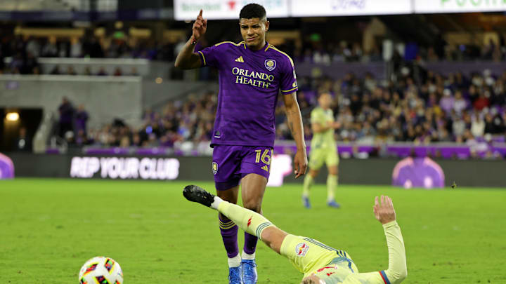 Nov 30, 2024; Orlando, Florida, USA; New York Red Bulls midfielder Emil Forsberg (10) falls after battling for the ball against Orlando City midfielder Wilder Cartagena (16) in the 2024 MLS Cup Eastern Conference Final match at Inter&Co Stadium. Mandatory Credit: Mike Watters-Imagn Images
