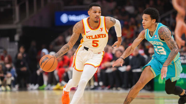 Mar 23, 2024; Atlanta, Georgia, USA; Atlanta Hawks guard Dejounte Murray (5) is defended by Charlotte Hornets guard Tre Mann (23) in the first quarter at State Farm Arena. Mandatory Credit: Brett Davis-USA TODAY Sports
