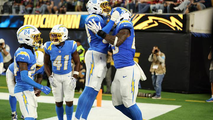 Aug 20, 2026; Inglewood, California, USA;  Los Angeles Chargers linebacker Junior Colson (25) celebrates with safety Devin Grant (38) after a pick six during the third quarter against the San Francisco 49ers at SoFi Stadium. Mandatory Credit: Kiyoshi Mio-Imagn Images
