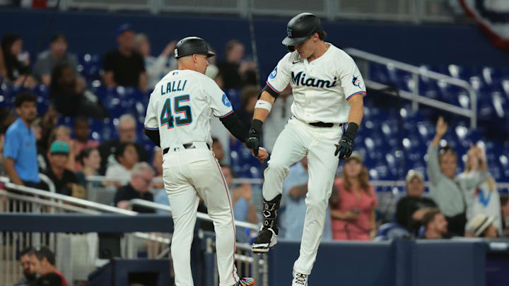 Miami Marlins right fielder Griffin Conine celebrates with third base coach 