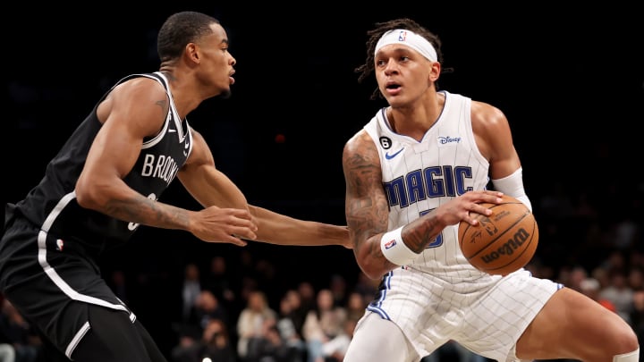 Nov 28, 2022; Brooklyn, New York, USA; Orlando Magic forward Paolo Banchero (5) controls the ball against Brooklyn Nets forward Nic Claxton (33) during the first quarter at Barclays Center. Mandatory Credit: Brad Penner-USA TODAY Sports