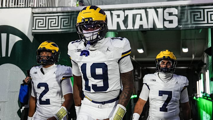 Michigan quarterback Bryce Underwood (19), center, quarterback Jadyn Davis (2), left, and quarterback Mikey Keene (7) take the field for warm up at Spartan Stadium in East Lansing on Saturday, October 25, 2025. Michigan quarterback Bryce Underwood (19), center, quarterback Jadyn Davis (2), left, and quarterback Mikey Keene (7) take the field for warm up at Spartan Stadium in East Lansing on Saturday, October 25, 2025.