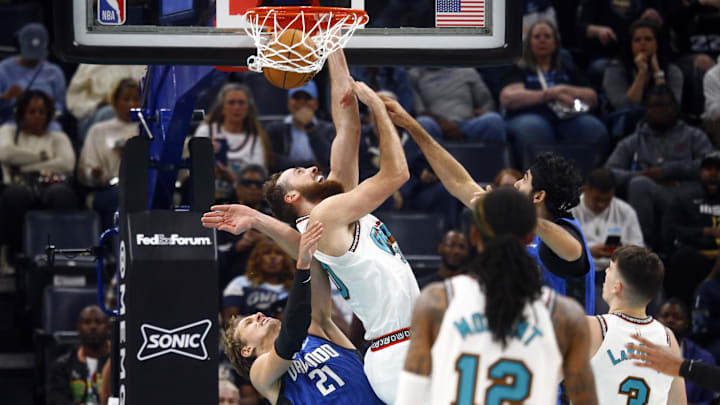 Oct 26, 2024; Memphis, Tennessee, USA; Memphis Grizzlies center Jay Huff (30) dunks over Orlando Magic center Moritz Wagner (21) during the first half at FedExForum. Mandatory Credit: Petre Thomas-Imagn Images