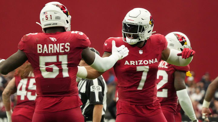 Arizona Cardinals linebackers Kyzir White (7) and Krys Barnes (51) celebrate their defensive stop against the Dallas Cowboys at State Farm Stadium in Glendale on Set. 24, 2023.