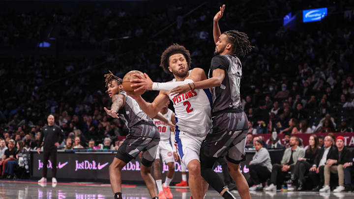 Jan 8, 2025; Brooklyn, New York, USA;  Detroit Pistons guard Cade Cunningham (2) looks to drive past Brooklyn Nets forward Ziaire Williams (8) in the second quarter at Barclays Center. Mandatory Credit: Wendell Cruz-Imagn Images