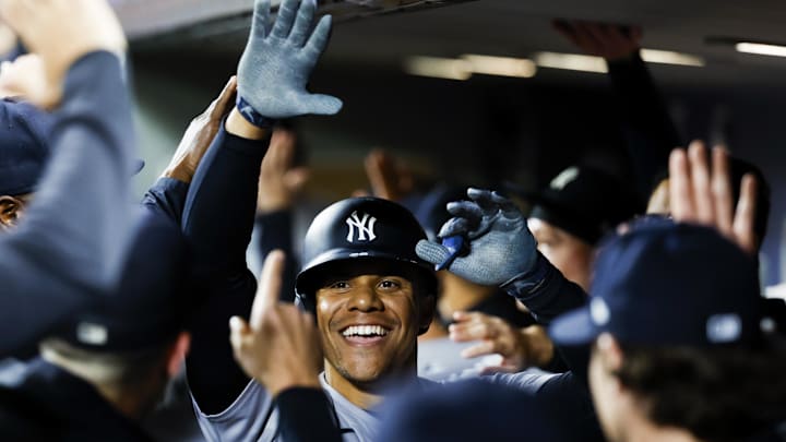 Sep 17, 2024; Seattle, Washington, USA; New York Yankees right fielder Juan Soto (22) celebrates with teammates in the dugout after hitting a two-run home run against the Seattle Mariners during the fourth inning at T-Mobile Park. Mandatory Credit: Joe Nicholson-Imagn Images