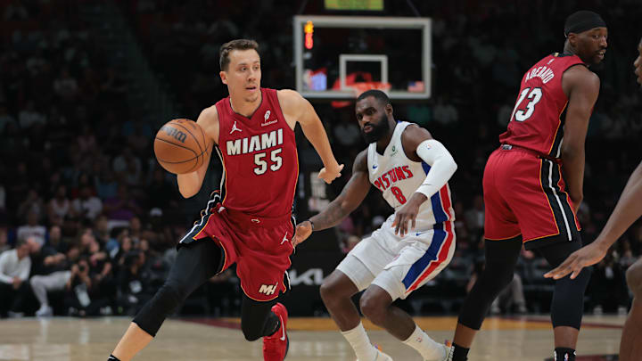 Mar 19, 2025; Miami, Florida, USA; Miami Heat forward Duncan Robinson (55) drives to the basket past Detroit Pistons forward Tim Hardaway Jr. (8) during the first quarter at Kaseya Center. Mandatory Credit: Sam Navarro-Imagn Images