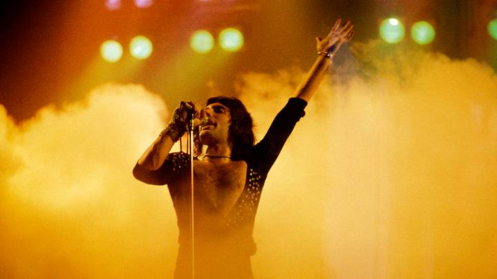Freddie Mercury of Queen performing in front of fog Freddie Mercury of Queen performing in front of fog