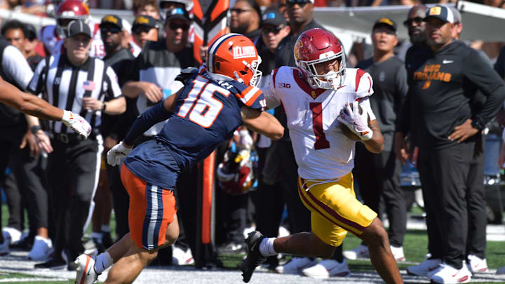 Sep 27, 2025; Champaign, Illinois, USA;  Illinois Fighting Illini defensive back Tanner Heckel (16) pushes Southern California Trojans running back Eli Sanders (1) out of bounds on a run during the first half at Memorial Stadium. Mandatory Credit: Ron Johnson-Imagn Images