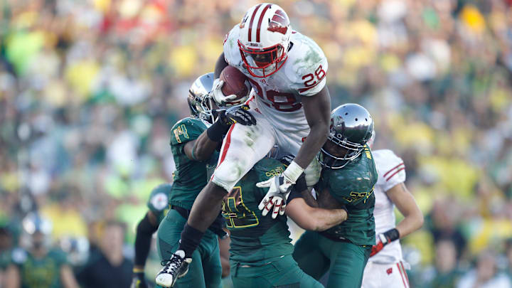 Wisconsin Badgers Montee Ball gains 13-yards against the Oregon Ducks Ifo Ekpre-Olomu, (14) John Boyett and (20) Terrance Mitchell (27) during the second half of the Rose Bowl in Pasadena, Calif. on January 2, 2012.