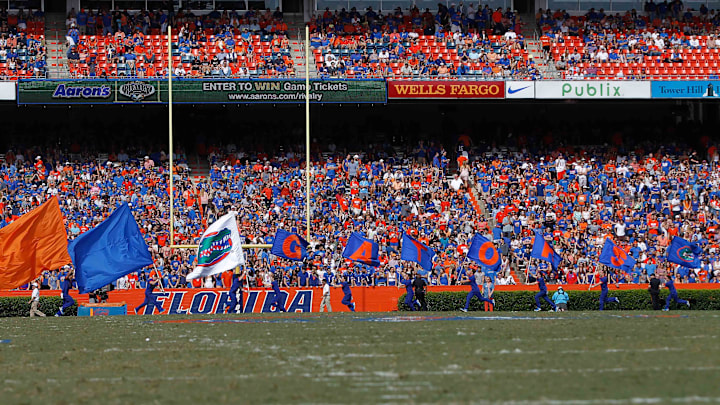 Nov 9, 2013; Gainesville, FL, USA; Florida Gators cheerleaders run across the field with flags